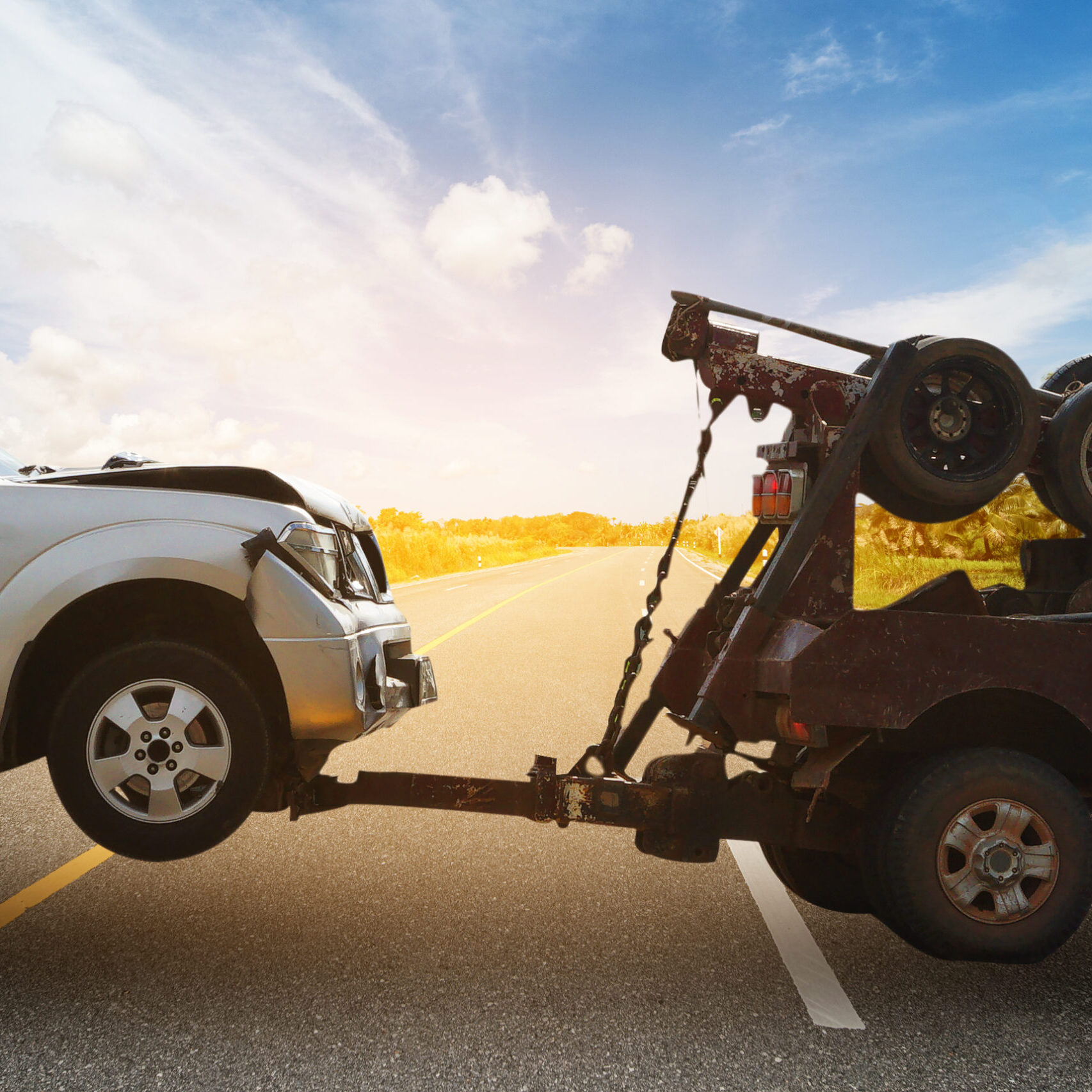 Tow,Truck,Delivers,The,Damaged,Vehicle,,Sun,Light,Flare,,Selective